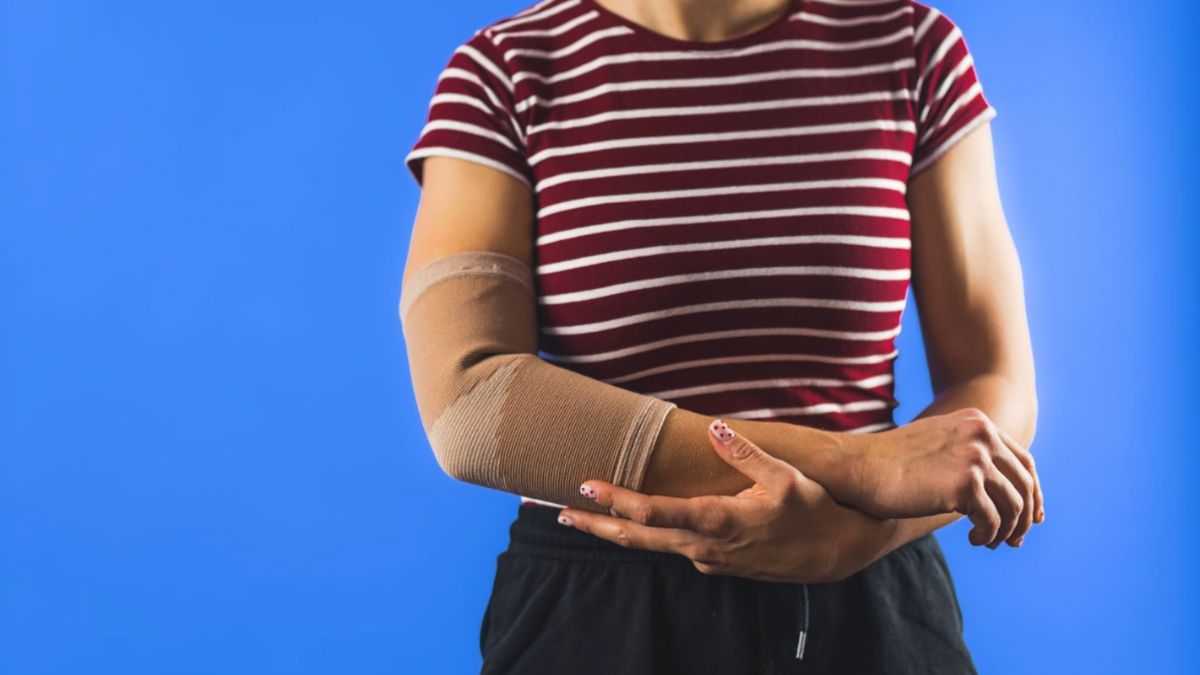 A woman wearing a compression sleeve in her arm, in need of CDT.