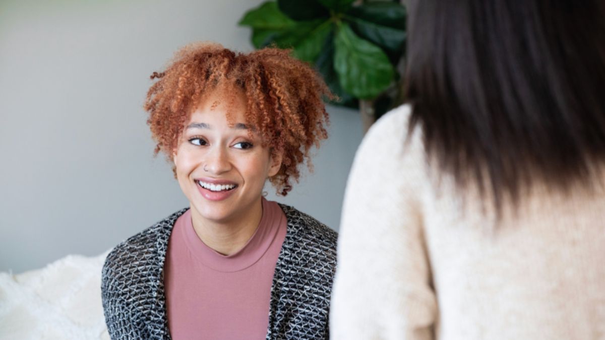 A woman with red hair discussing personal growth strategies with her life coach.