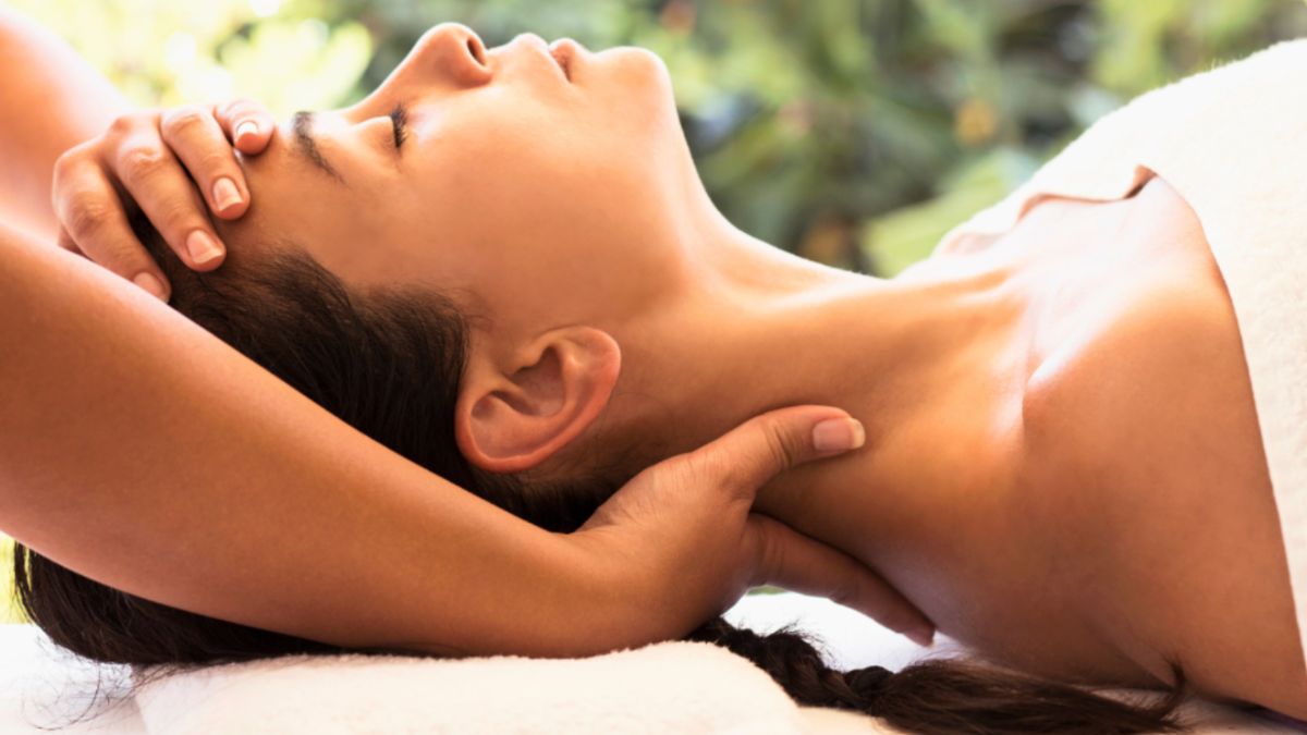A woman receiving a neck massage focusing on relaxation and healing after a post-mastectomy procedure.