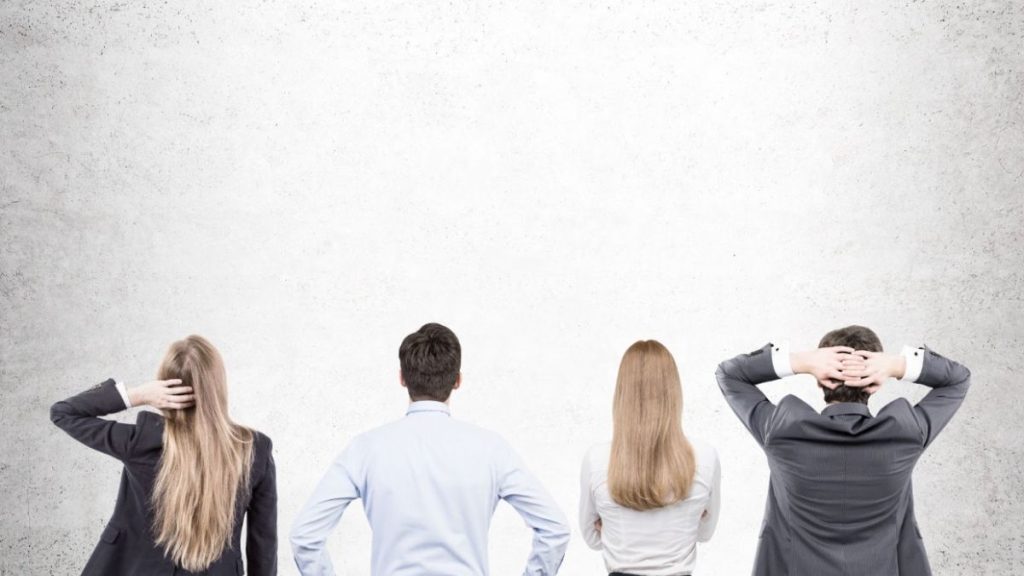 Business professionals standing in a row, representing collaboration in career transition coaching for future success.