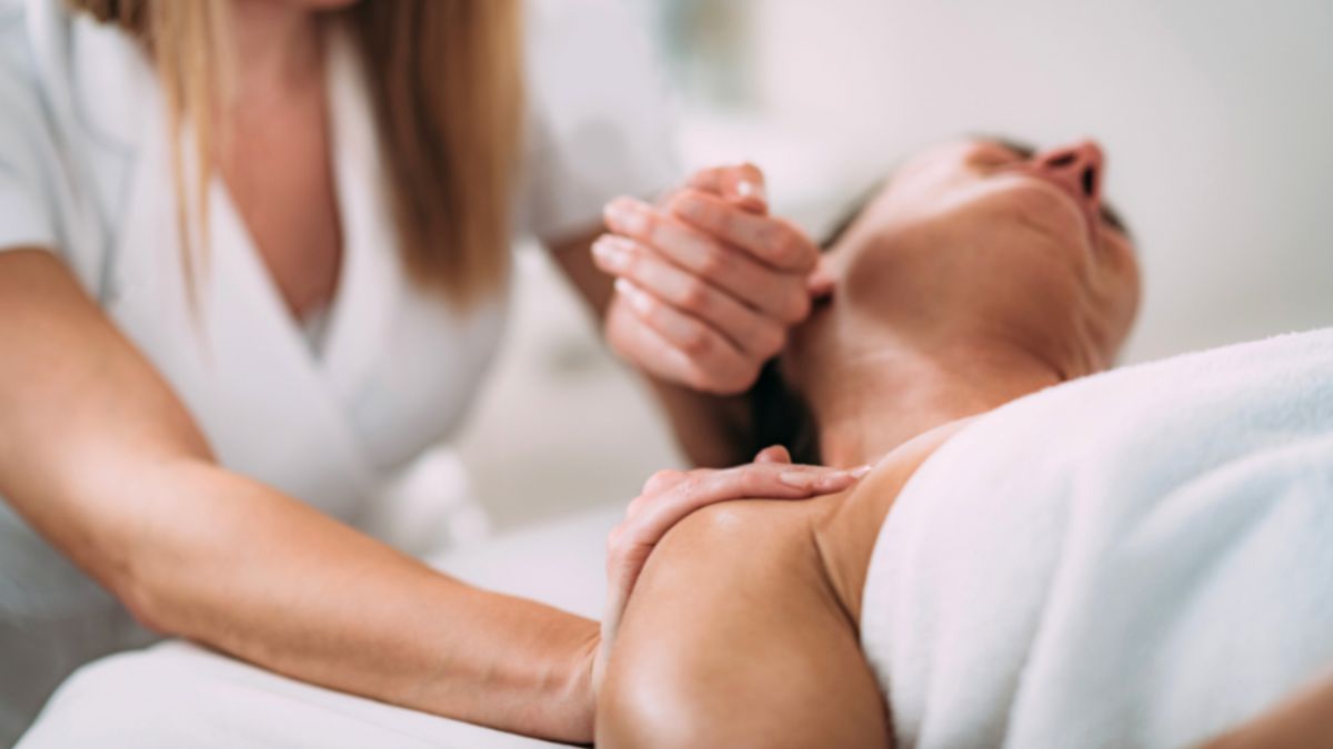 A woman receiving a lymph drainage therapy in a serene environment, promoting relaxation and wellness.